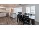 Bright kitchen with island that connects to an open floor plan dining area and living area with gray flooring at 3802 W Mission Ln, Phoenix, AZ 85051