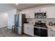 Bright kitchen features stainless appliances and white cabinetry at 3802 W Mission Ln, Phoenix, AZ 85051