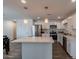 Bright kitchen features stainless appliances, white cabinetry, and a large center island with quartz countertop at 3802 W Mission Ln, Phoenix, AZ 85051
