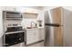 Modern kitchen with stainless steel appliances and neutral color palette at 3802 W Mission Ln, Phoenix, AZ 85051