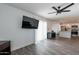 Open-concept living room flowing into kitchen with modern flooring and a mounted television at 3802 W Mission Ln, Phoenix, AZ 85051