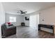 Open-concept living room featuring modern flooring, a ceiling fan, and recessed lighting at 3802 W Mission Ln, Phoenix, AZ 85051