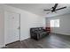 Comfortable living room with hardwood floors, a ceiling fan, and a gray leather sofa at 3802 W Mission Ln, Phoenix, AZ 85051