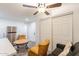 A well-lit living room featuring a ceiling fan and adjacent stainless steel refrigerator at 3802 W Mission Ln, Phoenix, AZ 85051