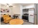 Living room with kitchen featuring modern appliances and neutral color palette at 3802 W Mission Ln, Phoenix, AZ 85051