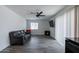 Bright living room with hardwood floors, a ceiling fan, and a cozy seating area at 3802 W Mission Ln, Phoenix, AZ 85051