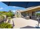 Serene back patio with comfortable seating, outdoor lighting, and views of the pool and lush landscaping at 3843 E Hazeltine Way, Chandler, AZ 85249
