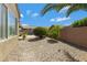 Gravel backyard featuring desert landscaping, mature trees, and a covered patio overlooking the pool at 3843 E Hazeltine Way, Chandler, AZ 85249