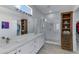 Bathroom featuring double sinks, white cabinetry, and glass enclosed shower for a spa-like feel at 3843 E Hazeltine Way, Chandler, AZ 85249