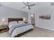 Serene bedroom with a modern ceiling fan, wood accent furniture, and ensuite bath at 3843 E Hazeltine Way, Chandler, AZ 85249