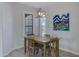Dining room features a wooden table set beneath an industrial light fixture and bright natural light at 3843 E Hazeltine Way, Chandler, AZ 85249