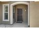 Exterior shot of the front door entry way featuring a stone archway and security door at 3843 E Hazeltine Way, Chandler, AZ 85249