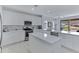 Bright, modern kitchen featuring white cabinetry, stainless steel appliances, and a large island at 3843 E Hazeltine Way, Chandler, AZ 85249