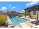 Sparkling pool with lounge chairs and umbrellas, surrounded by mature landscaping for a private oasis at 3843 E Hazeltine Way, Chandler, AZ 85249