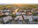 An aerial view of a sunlit neighborhood showcasing well-maintained houses and lush palm trees at 4020 N 151St Dr, Goodyear, AZ 85395