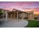 The back exterior features a covered patio with outdoor furniture and a well-manicured lawn at 4020 N 151St Dr, Goodyear, AZ 85395