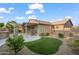 Expansive backyard featuring a covered patio, artificial turf, desert landscaping, and a well-maintained exterior at 4020 N 151St Dr, Goodyear, AZ 85395