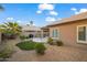 Spacious backyard oasis featuring artificial turf, desert landscaping, a covered patio, and an outdoor grill at 4020 N 151St Dr, Goodyear, AZ 85395