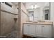 Tiled walk-in shower and double sink vanity with granite countertop in bathroom at 4020 N 151St Dr, Goodyear, AZ 85395