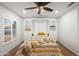 Bright bedroom with built-in shelving, a ceiling fan, and wood-look floors at 4020 N 151St Dr, Goodyear, AZ 85395