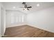 Bright bedroom featuring wood-look floors, ceiling fan, and windows with plantation shutters at 4020 N 151St Dr, Goodyear, AZ 85395