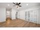 Spacious bedroom with wood-look floors, plantation shutters, and view to ensuite bathroom at 4020 N 151St Dr, Goodyear, AZ 85395