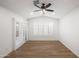 Bright bedroom featuring wood-look floors, ceiling fan, and windows with plantation shutters at 4020 N 151St Dr, Goodyear, AZ 85395
