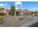 Single-Gathering home with neutral exterior paint and low maintenance desert landscaping at 4020 N 151St Dr, Goodyear, AZ 85395
