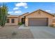 Charming single-story home with a neutral color palette, well-maintained landscaping, and a two-car garage at 4020 N 151St Dr, Goodyear, AZ 85395