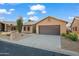 A beautiful home featuring a two-car garage with low maintenance desert landscaping at 4020 N 151St Dr, Goodyear, AZ 85395