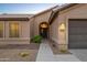 Inviting home exterior featuring a walkway leading to a charming front entrance with desert landscaping at 4020 N 151St Dr, Goodyear, AZ 85395