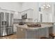 Modern kitchen with stainless steel appliances, granite countertops, and breakfast bar seating at 4020 N 151St Dr, Goodyear, AZ 85395