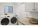 Laundry room includes granite countertops and front load washer and dryer at 4020 N 151St Dr, Goodyear, AZ 85395
