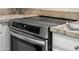 Close-up of modern stainless steel oven with cooktop and granite countertops at 4020 N 151St Dr, Goodyear, AZ 85395