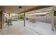 Relaxing covered patio area with concrete flooring, a ceiling fan, bar, and views of the well-manicured backyard at 4020 N 151St Dr, Goodyear, AZ 85395