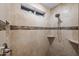 Shower with tiled walls, river rock floor, built-in niche and adjustable shower head at 4020 N 151St Dr, Goodyear, AZ 85395