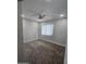 A carpeted bedroom with a ceiling fan and window with blinds at 4043 W Palomino Rd, Phoenix, AZ 85019
