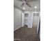 Cozy bedroom with ceiling fan, neutral walls and carpet, and walk in closet at 4043 W Palomino Rd, Phoenix, AZ 85019