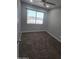 Bedroom featuring a large window and neutral walls with carpet flooring at 4043 W Palomino Rd, Phoenix, AZ 85019