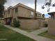 Two-story townhome featuring stucco exterior, well-maintained landscaping and private gated entry at 4043 W Palomino Rd, Phoenix, AZ 85019