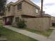 Two-story townhome featuring stucco exterior, well-maintained landscaping and private gated entry at 4043 W Palomino Rd, Phoenix, AZ 85019