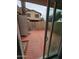 Enclosed outdoor patio viewed through sliding door showing a privacy wall, desert landscaping, and exterior access at 4043 W Palomino Rd, Phoenix, AZ 85019