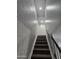 Carpeted staircase with railing and natural light fixtures at 4043 W Palomino Rd, Phoenix, AZ 85019