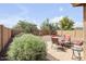 A spacious backyard featuring desert landscaping, a seating area and privacy walls at 41341 W Little Dr, Maricopa, AZ 85138