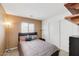 Inviting bedroom with a comfortable queen bed, complemented by natural light from the window and a spacious closet at 41341 W Little Dr, Maricopa, AZ 85138