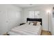 Cozy bedroom with a queen bed, soft striped bedding, and a sliding door closet, creating a tranquil and organized space at 41341 W Little Dr, Maricopa, AZ 85138