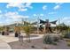 Community playground featuring a covered picnic area and modern play structure with slides, perfect for outdoor recreation at 41341 W Little Dr, Maricopa, AZ 85138