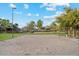 An outdoor sand volleyball court surrounded by grass and trees, promoting an active lifestyle at 41341 W Little Dr, Maricopa, AZ 85138