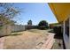 The backyard features a lawn and a block fence with a patio in the background at 4153 W Sunnyside Ave, Phoenix, AZ 85029