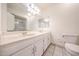 Bathroom featuring double sinks with white cabinets and a shower behind sliding doors at 4153 W Sunnyside Ave, Phoenix, AZ 85029